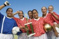 Female Soccer Team Holding Trophy