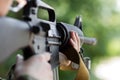 Female soldier shooting with a gun