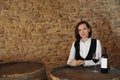 Female sommelier with glass and bottle of red wine