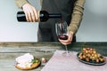 Female sommelier pouring red wine