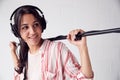 Female Sound Recordist Holding Microphone On Video Film Production In White Studio
