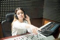 Female sound technician indicating to start radio show