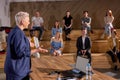 Female speaker giving presentation in hall in university. group of young people in audience Royalty Free Stock Photo