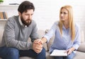 Female specialist supporting depressed patient at personal therapy in office