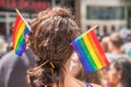 A female spectator with two rainbow flag hair sticks