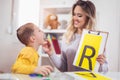 Speech therapist teaches the boys to say the letter R Royalty Free Stock Photo