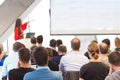 Female speeker having talk at public event.