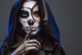 Female with spooky painted face and finger on lips Royalty Free Stock Photo