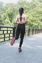 Female sport fitness runner jogging outdoors on bridge in spring Royalty Free Stock Photo