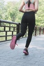 Female sport fitness runner jogging outdoors on bridge in spring Royalty Free Stock Photo