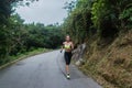 Female sport model running on road in mountains. Fitness woman training outdoors. Royalty Free Stock Photo