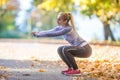 Female sporty young woman doing stretching or warming the body and preparing to jogging