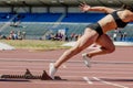 female sprinter start running from starting blocks running Royalty Free Stock Photo