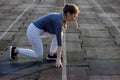 Female sprinter waiting for the start on an airport runway