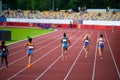 Female Sprinters in Full Stride during a 400m Race on the Athletics Track. Track and field illustration photo for Worlds in Royalty Free Stock Photo