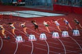 Female Sprinters Propel Themselves Down the Track in the Initial Moments of a 100m Race Royalty Free Stock Photo