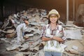 Female staff Controlling separation of paper for recycling