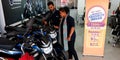 female staff displaying motorcycle latest model into the bajaj showroom in India aug 2019