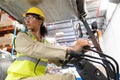 Female staff driving forklift in warehouse