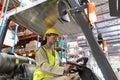 Female staff driving forklift in warehouse Royalty Free Stock Photo