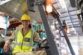 Female staff driving forklift in warehouse Royalty Free Stock Photo