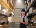 Female staff Lifting parcel boxes in the warehouse