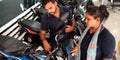 female staff looking for bike testing at bajaj bike showroom in India