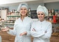 Female staff offering sweets in local confectionery Royalty Free Stock Photo