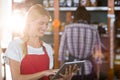 Female staff using digital tablet in supermarket Royalty Free Stock Photo