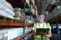 Female staff using digital tablet in warehouse