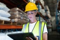 Female staff using digital tablet in warehouse