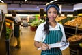 Female staff writing on notepad in super market