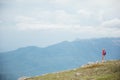 female traveler standing on top of a mountain looking at the view Royalty Free Stock Photo