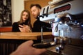 Female starting her day on a new job as a barista. Working in a cafe.