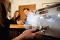 Female starting her day on a new job as a barista. Working in a cafe.