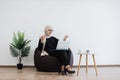 Female starting online meeting via computer in workplace