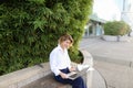 Statistician working outside with laptop and color diagrams. Royalty Free Stock Photo