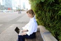 Statistician working outside with laptop and color diagrams. Royalty Free Stock Photo
