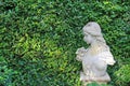 Female statue made from mortar in the summer garden with copy space. Decorative gardens Royalty Free Stock Photo