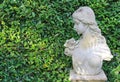 Female statue made from mortar in the summer garden with copy space. Decorative gardens Royalty Free Stock Photo