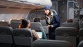 Female stewardess asking passengers about airline services