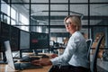 Female stockbroker in formal clothes works in the office with financial market Royalty Free Stock Photo