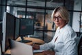 Female stockbroker in formal clothes works in the office with financial market Royalty Free Stock Photo