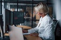 Female stockbroker in formal clothes works in the office with financial market Royalty Free Stock Photo