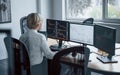 Female stockbroker in formal clothes works in the office with financial market Royalty Free Stock Photo