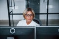 Female stockbroker in formal clothes works in the office with financial market Royalty Free Stock Photo