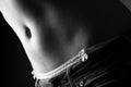 Female stomach and pantie with ribbon and jeans - black and white Royalty Free Stock Photo