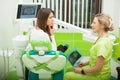 Female stomatologist in protective gloves examining patient`s teeth. Dentist caries treatment at dental clinic office Royalty Free Stock Photo