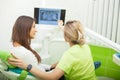 Female stomatologist in protective gloves examining patient`s teeth. Dentist caries treatment at dental clinic office Royalty Free Stock Photo