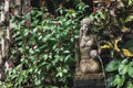 Female stone carved statuette as fountain in balinese traditional garden